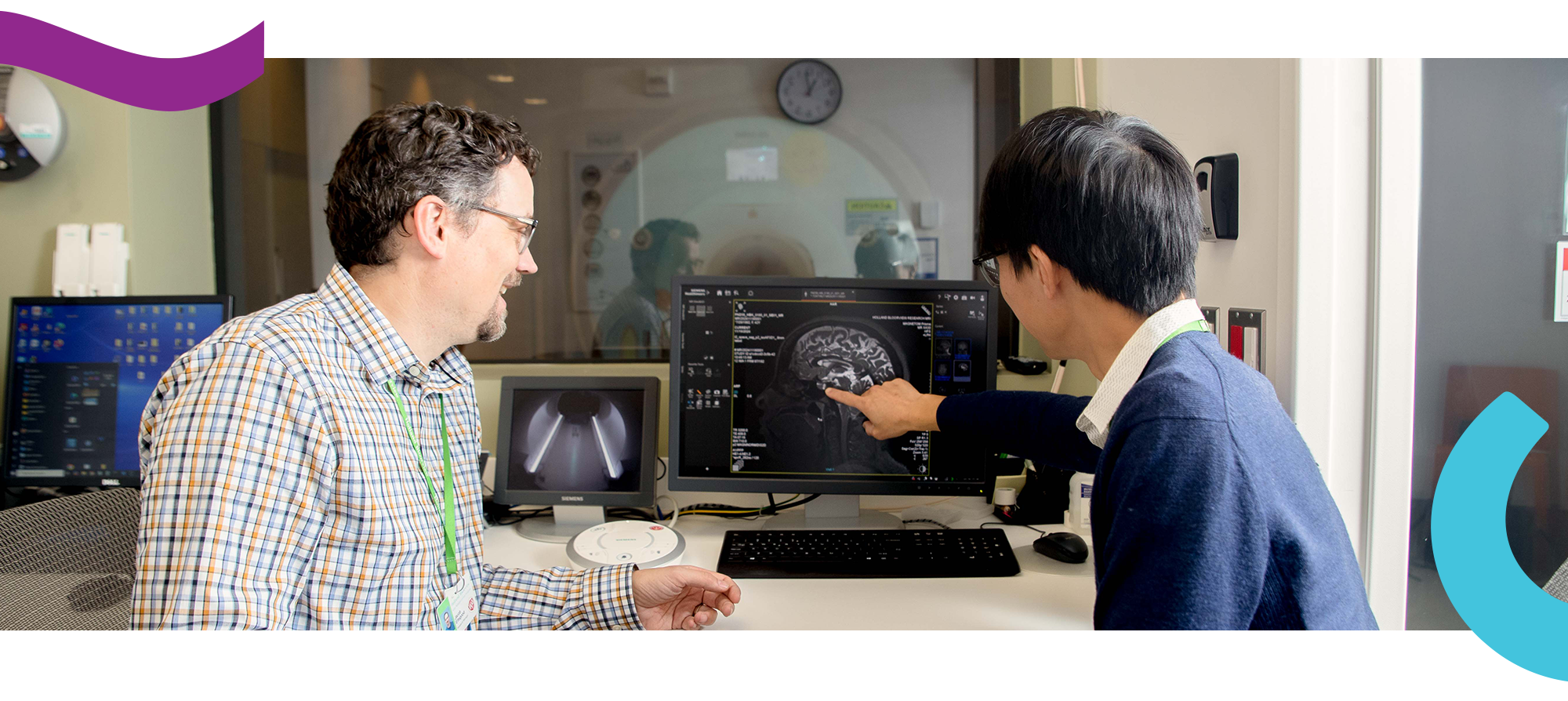 Two adults look at a brain scan image