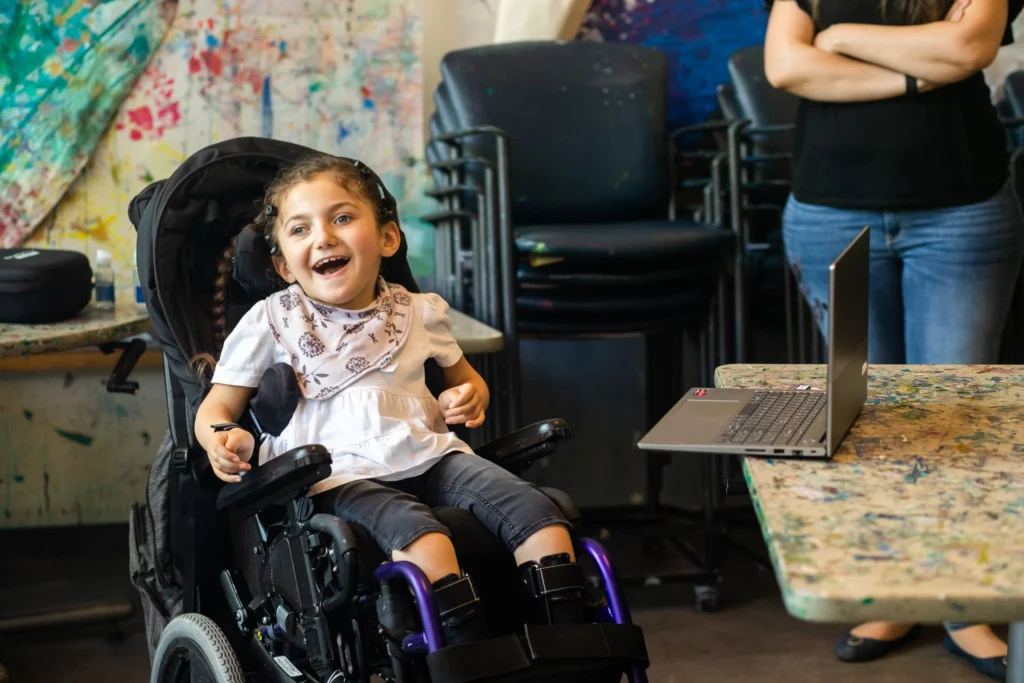 A young girl uses brain computer interface technology to move her wheelchair