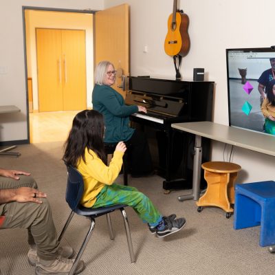 A child plays music with a virtual instrument