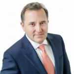 Capture An adult wears a suit in front of a white background