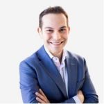 Mo Lidsky An adult wears a suit in front of a white background