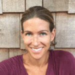 Rachel Kimmel new headshot for web An adult smiles in front of a wall covered in book pages