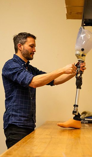 about3 An adult works on a prosthetic leg