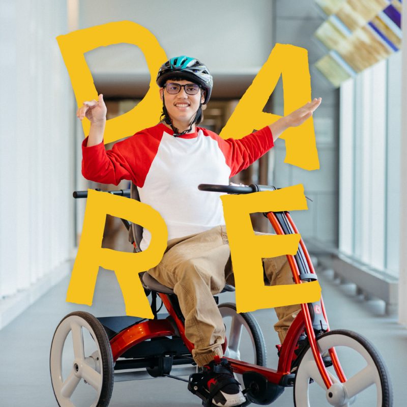 A teenager uses an adaptive bike